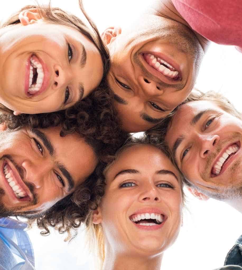 Smiling person showcasing white teeth after laser whitening treatment England